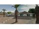 Cozy single story home with large front yard and mature palm trees at 3341 E Cochise Rd, Phoenix, AZ 85028