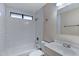 Bathroom featuring tiled walls, a shower/tub combo, and a white vanity sink at 3491 N Arizona Ave # 174, Chandler, AZ 85225