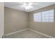 Neutral bedroom featuring updated carpeting, a window with blinds, and a ceiling fan at 3491 N Arizona Ave # 174, Chandler, AZ 85225