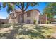 Exterior view of a condo with a large tree in the front yard at 3491 N Arizona Ave # 174, Chandler, AZ 85225