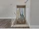 The upstairs hallway features hardwood floors, modern white trim, and a glimpse into the bathroom at 3491 N Arizona Ave # 174, Chandler, AZ 85225