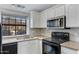 Modern kitchen features white cabinetry, marble backsplash, and granite countertops with stainless steel appliances at 3491 N Arizona Ave # 174, Chandler, AZ 85225