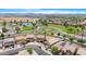 Community aerial view with ponds, palm trees, lush landscaping and neighborhood swimming pools at 36265 W Alhambra St, Maricopa, AZ 85138