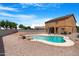 Backyard featuring a uniquely shaped pool, perfect for relaxation and outdoor entertainment at 36265 W Alhambra St, Maricopa, AZ 85138