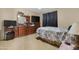 Bedroom with dresser, dark curtains and a large window providing natural light at 36265 W Alhambra St, Maricopa, AZ 85138