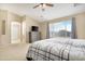 Bedroom highlighting a large window, TV, dresser, and stylish bedding at 36265 W Alhambra St, Maricopa, AZ 85138