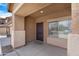 Covered front entryway leading to a dark wood door and sidelight window at 36265 W Alhambra St, Maricopa, AZ 85138