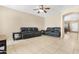 Spacious living room with tile flooring and comfortable leather sofas at 36265 W Alhambra St, Maricopa, AZ 85138