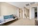 Spacious loft featuring neutral carpet, a futon, and doorways leading to other rooms at 36265 W Alhambra St, Maricopa, AZ 85138