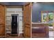 Convenient bar area with custom cabinets, a wine fridge, granite countertops, and easy access to the outdoor living spaces at 3731 E Halifax Cir, Mesa, AZ 85205