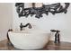 Close-up view of the powder room with a stone basin sink and a dark bronze faucet at 3731 E Halifax Cir, Mesa, AZ 85205