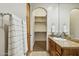 Bathroom featuring granite countertop, wood cabinets, mirror and a walk-in closet at 3731 E Halifax Cir, Mesa, AZ 85205