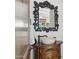 Powder room with a stone basin sink, custom vanity and mirror with ornate details at 3731 E Halifax Cir, Mesa, AZ 85205