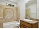 Bathroom with a tiled shower and backsplash with a granite sink counter top at 3731 E Halifax Cir, Mesa, AZ 85205