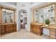 Dual sink vanities are featured in this bright and open bathroom with an archway view to the bedroom at 3731 E Halifax Cir, Mesa, AZ 85205