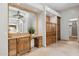Well-lit bathroom features a vanity with lots of storage and a view to the walk-in closet at 3731 E Halifax Cir, Mesa, AZ 85205