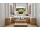 The luxurious bathtub is set inside a brick alcove by a window with views of the yard at 3731 E Halifax Cir, Mesa, AZ 85205