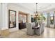 Bright dining room with a brick accent wall, travertine floors, and views to the backyard at 3731 E Halifax Cir, Mesa, AZ 85205