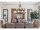 Elegant dining room displaying a wooden table set with decor under a decorative chandelier at 3731 E Halifax Cir, Mesa, AZ 85205