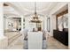 Elegant dining room with a stunning chandelier, neutral colors, and views into the living area, ideal for gatherings at 3731 E Halifax Cir, Mesa, AZ 85205