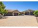 Large driveway with multiple garages on a sunny day with mature landscaping at 3731 E Halifax Cir, Mesa, AZ 85205