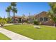 A luxurious property showcasing a beautifully landscaped front lawn, elegant stone accents, and a covered entrance at 3731 E Halifax Cir, Mesa, AZ 85205