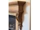 Close-up of the elegant, custom-carved wood detailing of the stone fireplace mantel at 3731 E Halifax Cir, Mesa, AZ 85205