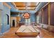 Spacious game room features a pool table, bar, wine storage, and custom finishes for a luxurious entertainment experience at 3731 E Halifax Cir, Mesa, AZ 85205