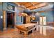 Luxurious game room boasts a beautiful pool table, custom ceiling, and bar for the best in relaxation and entertainment at 3731 E Halifax Cir, Mesa, AZ 85205