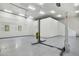 Spacious garage with modern lighting, car lift and epoxy floors, perfect for car enthusiasts at 3731 E Halifax Cir, Mesa, AZ 85205