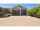 A home with two garages and a brick driveway with mature landscaping at 3731 E Halifax Cir, Mesa, AZ 85205
