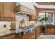 Beautiful kitchen with wood cabinets, stainless steel appliances, and view to the backyard at 3731 E Halifax Cir, Mesa, AZ 85205