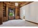 Large living room with beautiful wood paneling and access to the bathroom at 3731 E Halifax Cir, Mesa, AZ 85205