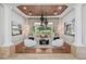 Elegant living room with a decorative ceiling, hardwood floors, statement lighting, and a backyard view at 3731 E Halifax Cir, Mesa, AZ 85205