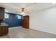 A view of the living room with a Murphy bed, wooden cabinets, and gray floors at 3731 E Halifax Cir, Mesa, AZ 85205