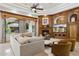 Inviting living room with wood built-ins surrounding the fireplace and a view to the backyard at 3731 E Halifax Cir, Mesa, AZ 85205