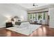 Bright main bedroom features a tray ceiling, a sitting area, and large windows at 3731 E Halifax Cir, Mesa, AZ 85205