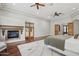 Spacious main bedroom with a fireplace, hardwood floors, ceiling fans, and access to the patio at 3731 E Halifax Cir, Mesa, AZ 85205