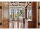 Elegant office featuring custom cabinetry, hardwood floors, and arched windows providing ample natural light for a sophisticated workspace at 3731 E Halifax Cir, Mesa, AZ 85205