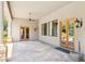 Covered outdoor patio featuring stone flooring, ceiling fan, and outdoor lighting at 3731 E Halifax Cir, Mesa, AZ 85205
