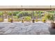 Covered outdoor patio featuring stone flooring with columns, landscaping and pool view at 3731 E Halifax Cir, Mesa, AZ 85205