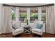 Inviting sitting area with cushioned chairs overlooking the beautifully landscaped backyard at 3731 E Halifax Cir, Mesa, AZ 85205