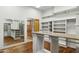 Beautiful walk-in closet with custom storage and a vanity with a granite countertop at 3731 E Halifax Cir, Mesa, AZ 85205