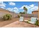 Relaxing backyard with a brick patio, seating, and well-maintained desert landscaping at 40089 W Bonneau St, Maricopa, AZ 85138