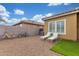 Spacious backyard with lounge chairs, bicycles, desert landscaping, and privacy walls at 40089 W Bonneau St, Maricopa, AZ 85138