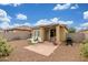 Inviting backyard with patio, lounge seating, drought-tolerant landscaping, and privacy fence at 40089 W Bonneau St, Maricopa, AZ 85138