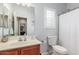 The bathroom features a vanity with a sink and a mirror and a shower with a white curtain at 40089 W Bonneau St, Maricopa, AZ 85138
