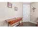 Warm entryway featuring a wooden console table, tiled floors, and decorative wall art at 40089 W Bonneau St, Maricopa, AZ 85138