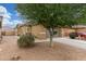 Exterior view of a desert home, showcasing a two-car garage and drought-tolerant landscaping at 40089 W Bonneau St, Maricopa, AZ 85138