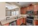 Charming kitchen with granite counters, stainless appliances, and convenient pass-through window at 40089 W Bonneau St, Maricopa, AZ 85138